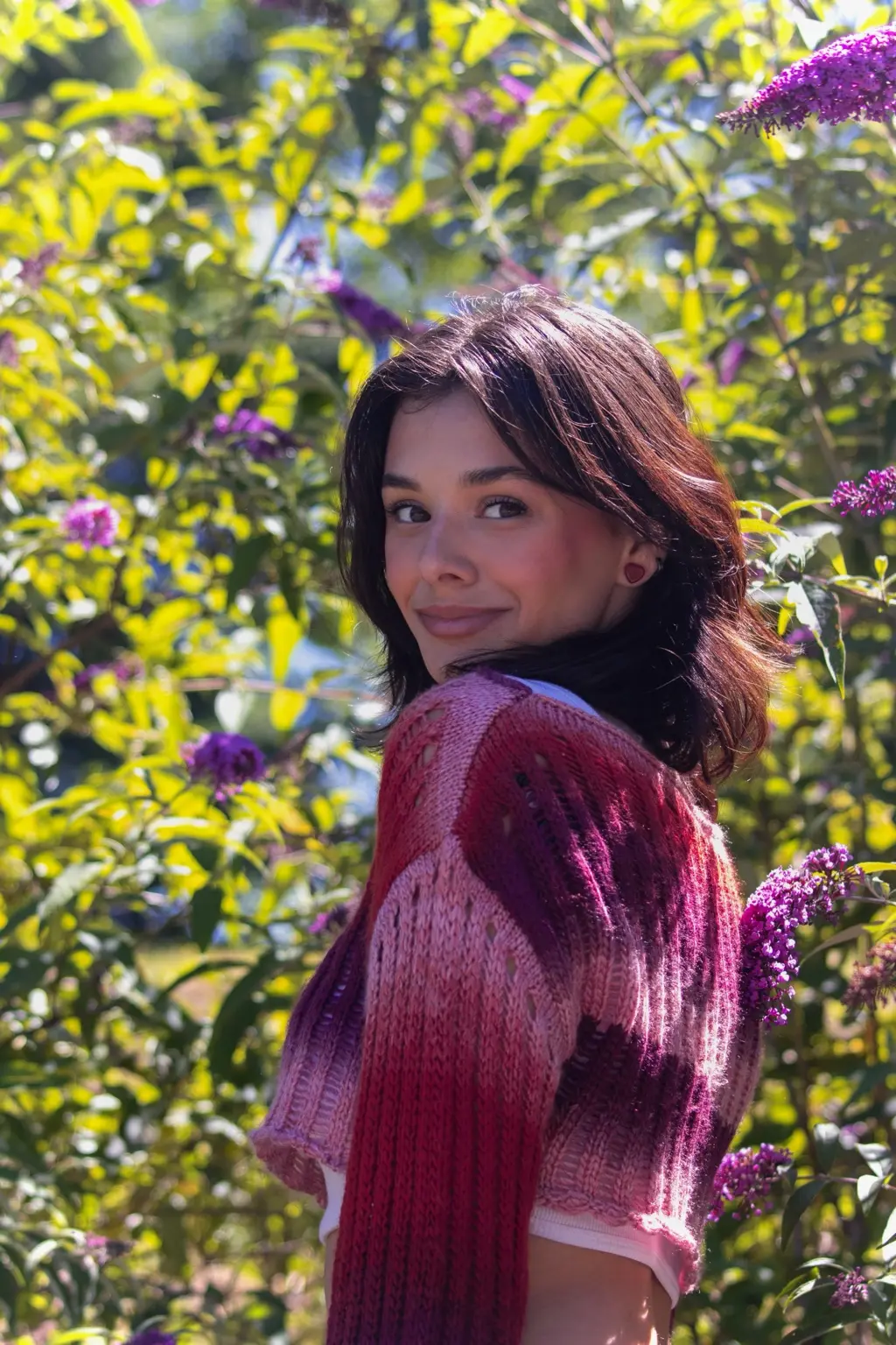Portrait of artist Jocelyn Chance Fautz outdoors among flowering plants